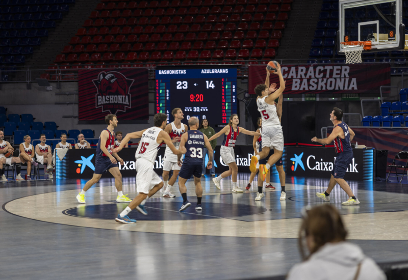 Jugadors disputant el partit Un dels jugadors salta a la recerca de la pilota