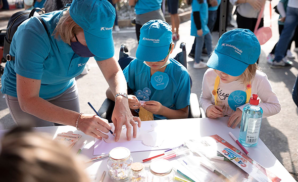 Voluntària dibuixant amb nens