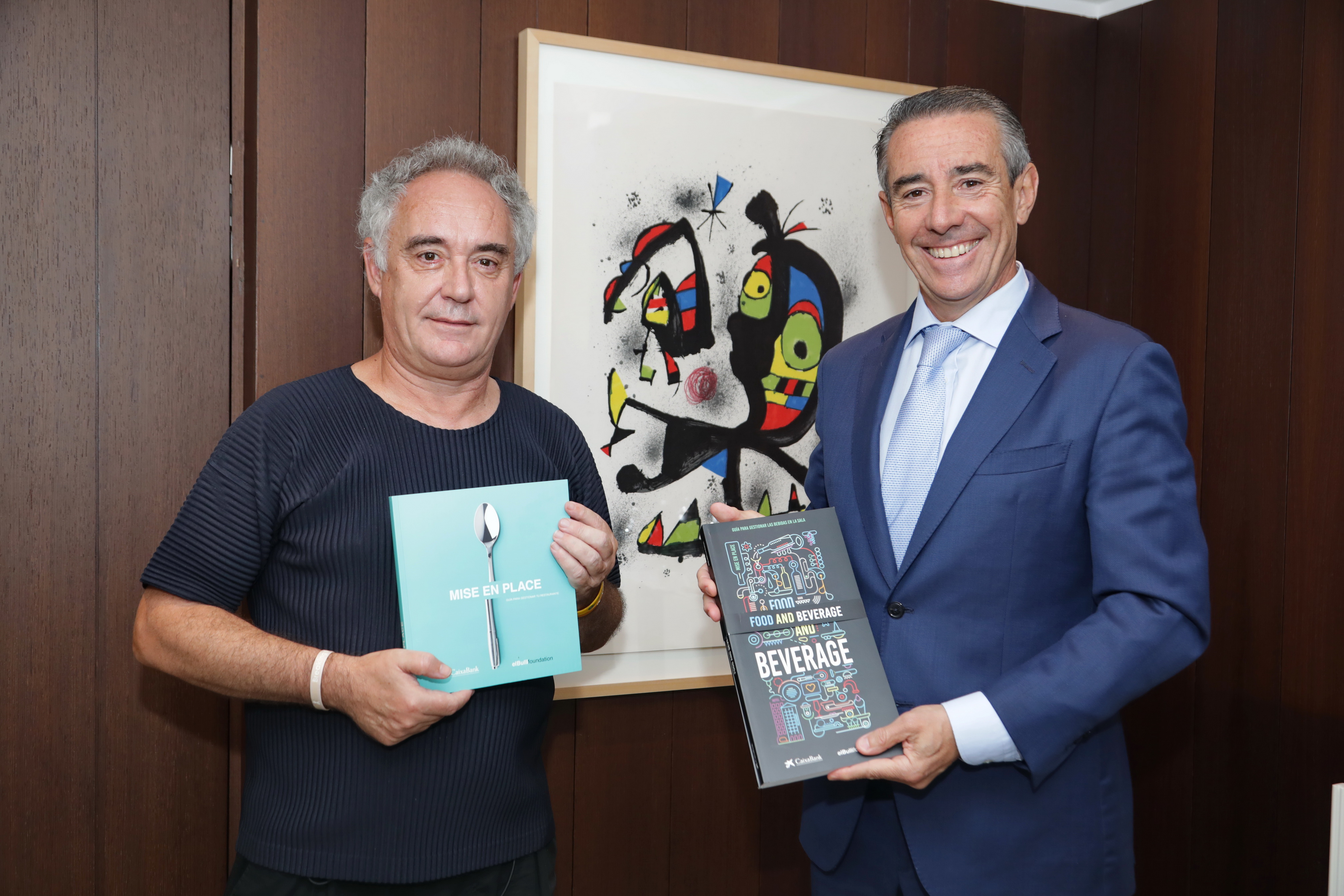 Juan Antonio Alcaraz, director general de CaixaBank, i Ferran Adrià, president de elBullifoundation, mostren les dues guies elaborades conjuntament per totes dues companyies –Mise and Place (2016) i Food and Beverage (2018)- per a impulsar la innovació en el sector de la restauració