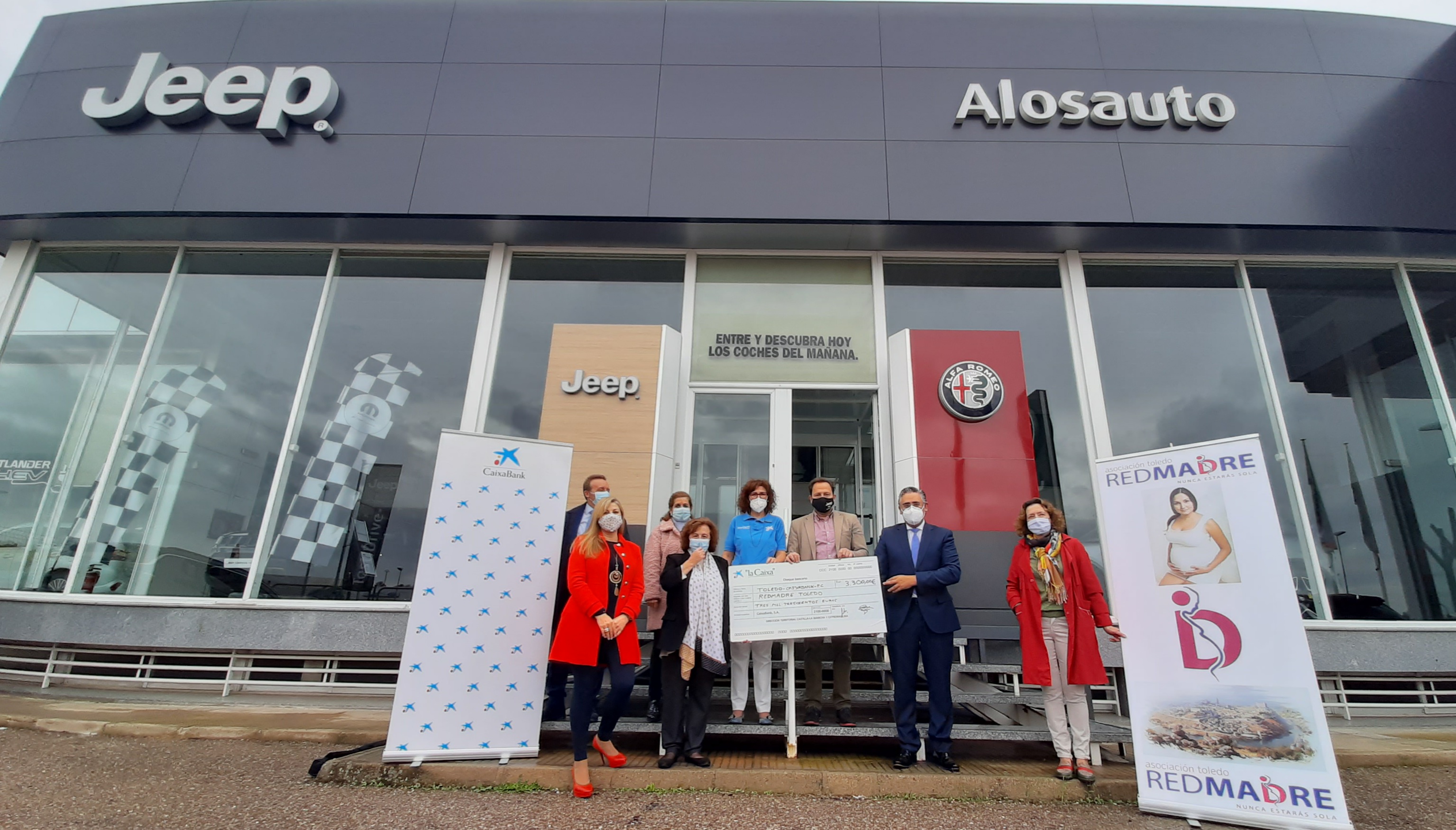 Sujetando el cheque están Ana Pérez, presidenta de Red Madre Toledo y Alfonso Ortega, director de área de negocio de CaixaBank en Toledo. Además, les acompañan, Ángel Alonso, gerente del Concesionario Alonso Pineda, Yolanda Arenas, delegada de los voluntarios de CaixaBank en Castilla La Mancha, César Jimeno, responsable de acción social de CaixaBank en Castilla -La Mancha, Elena Viñuales, voluntaria de Red Madre Toledo y Rosa Martín, organizadora por parte de Red Madre Toledo.