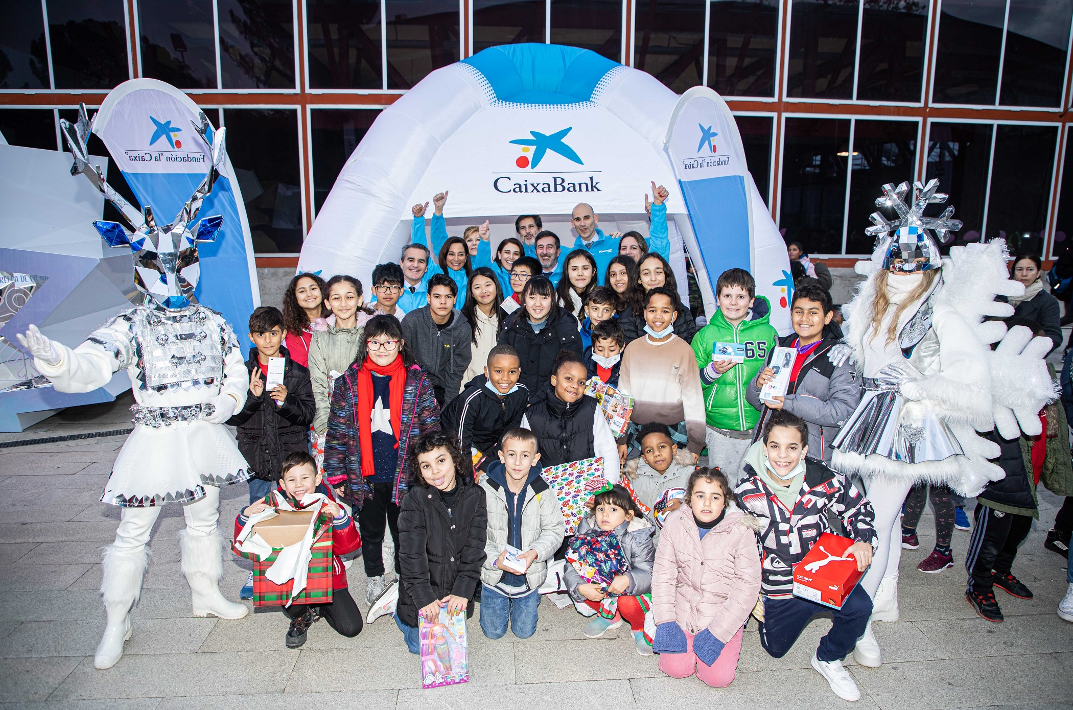 Foto de familia de menores que forman parte del programa CaixaProinfancia de la Fundación “la Caixa” con el director territorial Madrid Metropolitana de CaixaBank, Rafael Herrador, y voluntarios de CaixaBank