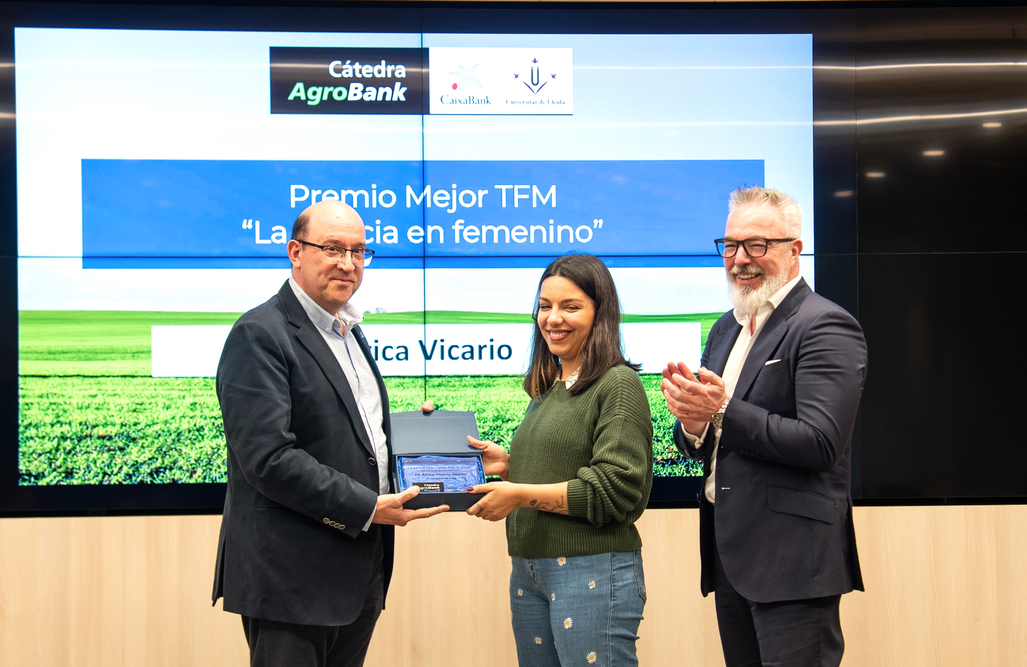 El director de la Càtedra AgroBank de la Universitat de Lleida, Antonio Ramos, entrega el premi a l'autora del treball guanyador, Àfrica Vicario, juntament amb el director de Red AgroBank, Carlos Seara.