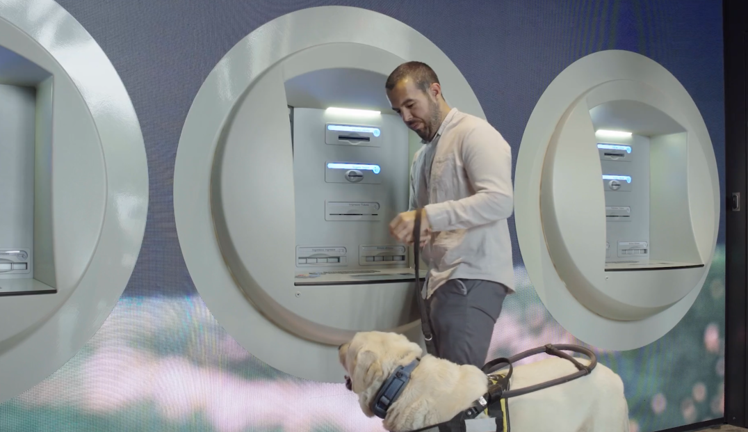 A visually impaired customer uses an accessible CaixaBank ATM.