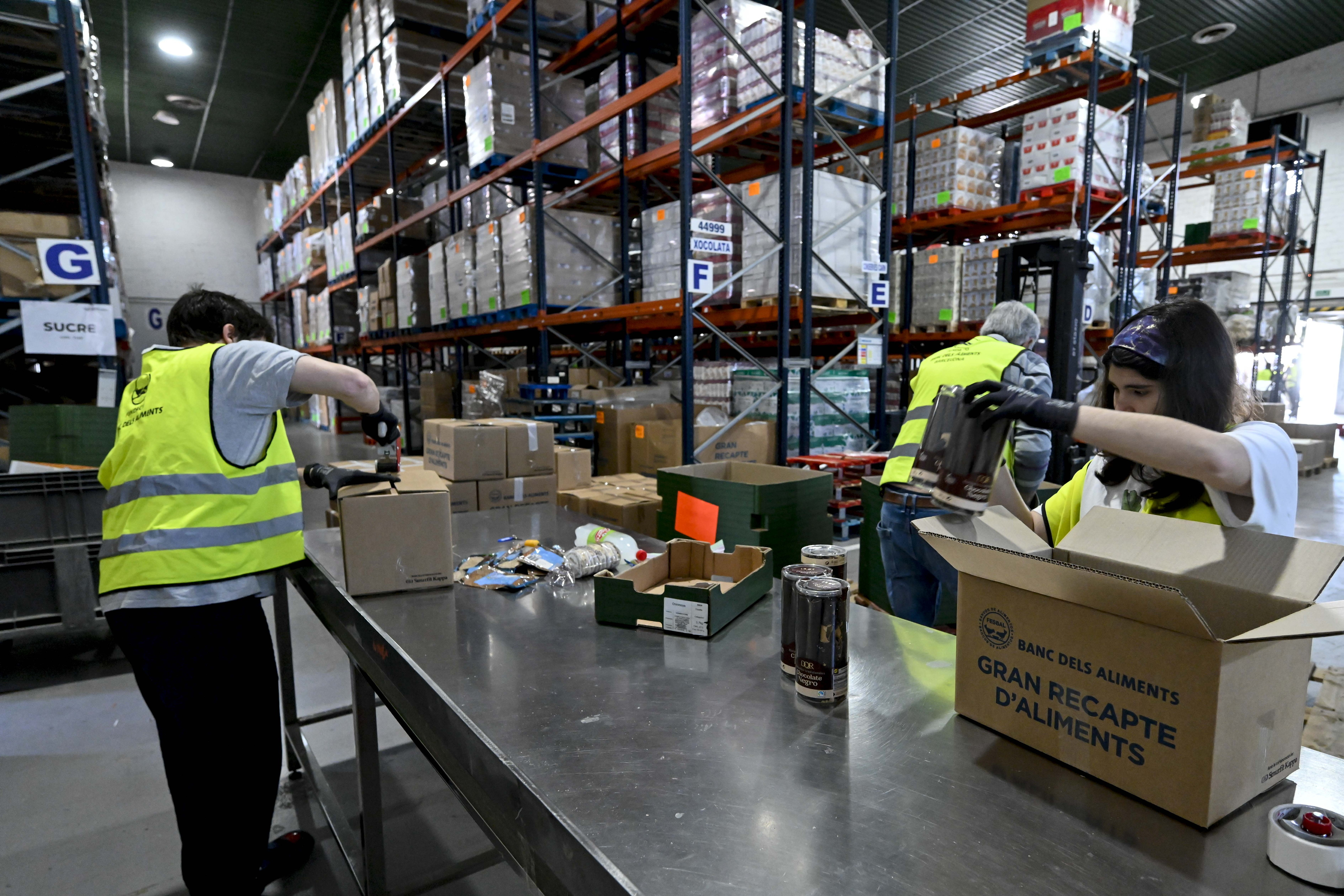 Volunteers prepare and organize food in a warehouse for subsequent distribution through Food Banks.