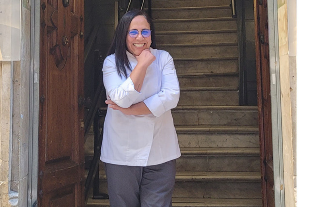 Patricia Lucero, propietaria de Oh My God! posa delante de unas escaleras y una puerta de madera