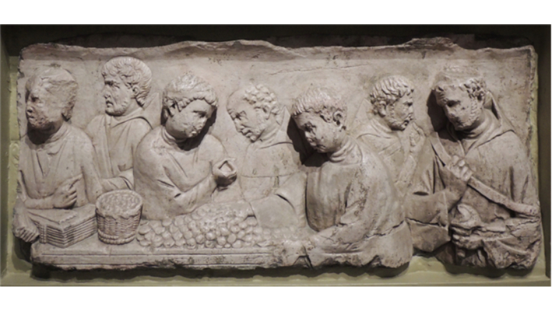 Relieve de piedra caliza que muestra una escena de pago de impuestos